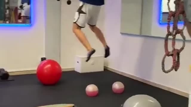 Guy Balances And Jumps On Various Gym Equipment While Working Out