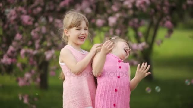 girls whispering and smiling