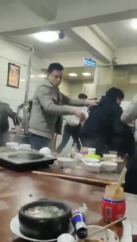 Person Keeps Eating During Restaurant Brawl