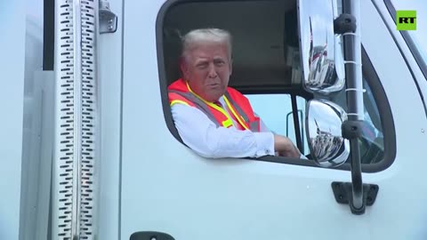 Trump talks to press from a garbage truck. "‘How do you like my garbage truck?"