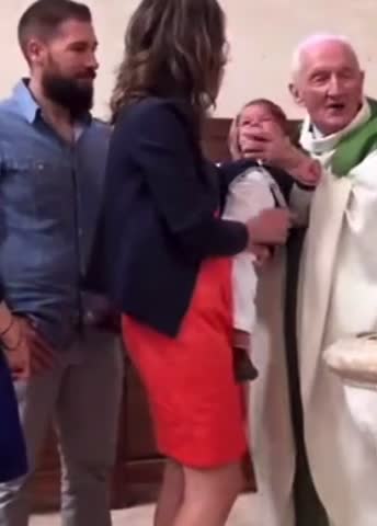 Evil priest slaps baby in the face