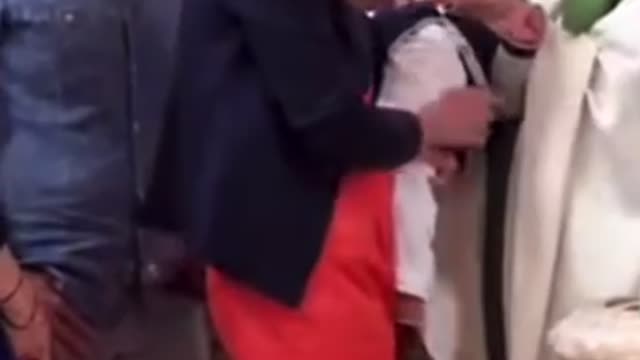 Evil priest slaps baby in the face