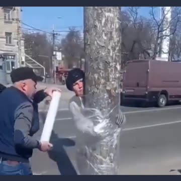 Ukraine Russia War Woman gets tied to a tree for stealing