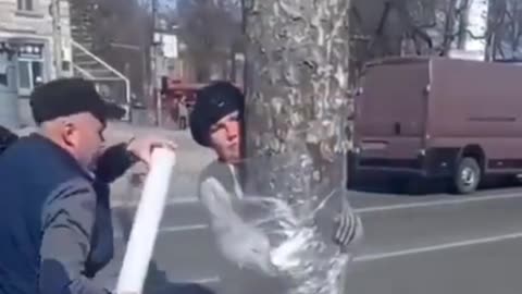 Ukraine Russia War Woman gets tied to a tree for stealing