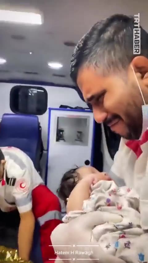 Gaza Emergency Worker Breaks Down in Tears Cradling a Baby in an Ambulance