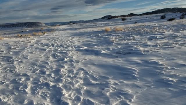 Hiking in 30 mph wind on snow-covered mesa top