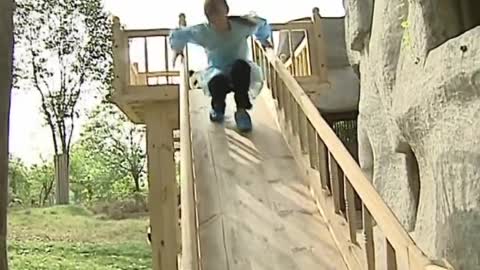 Cute pandas playing on the slide