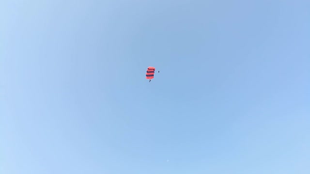 brave parachute jumping on the building