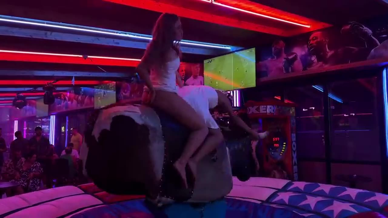 Spanish Resort Rodeoš® Dressed-Up Girl Riding on a Bull in Benidorm