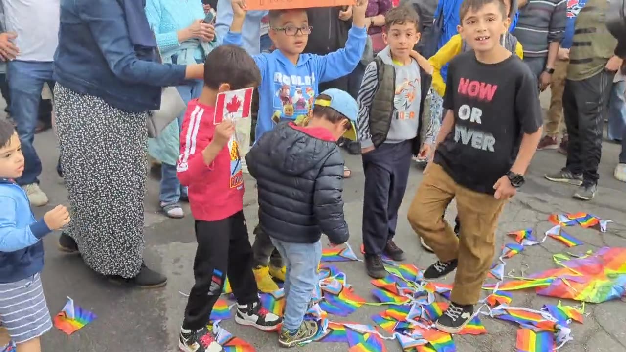 Young muslim kids STOMP the pride flag as their mothers cheer them on