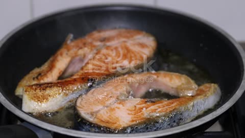 Frying Fresh Salmon In Frying Pan Stock,