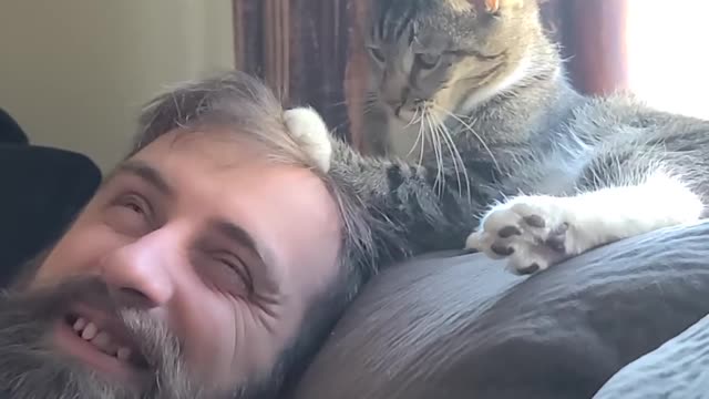 Cat Accidentally Pokes Tiny Paw Into Owner's Eye While Cuddling With Him