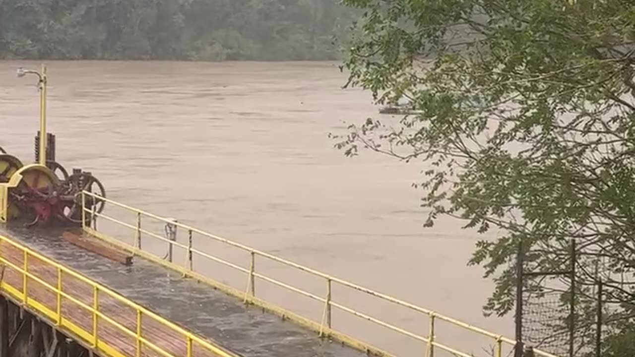 Pontoon Boat Goes Over Flooded Dam in Virginia