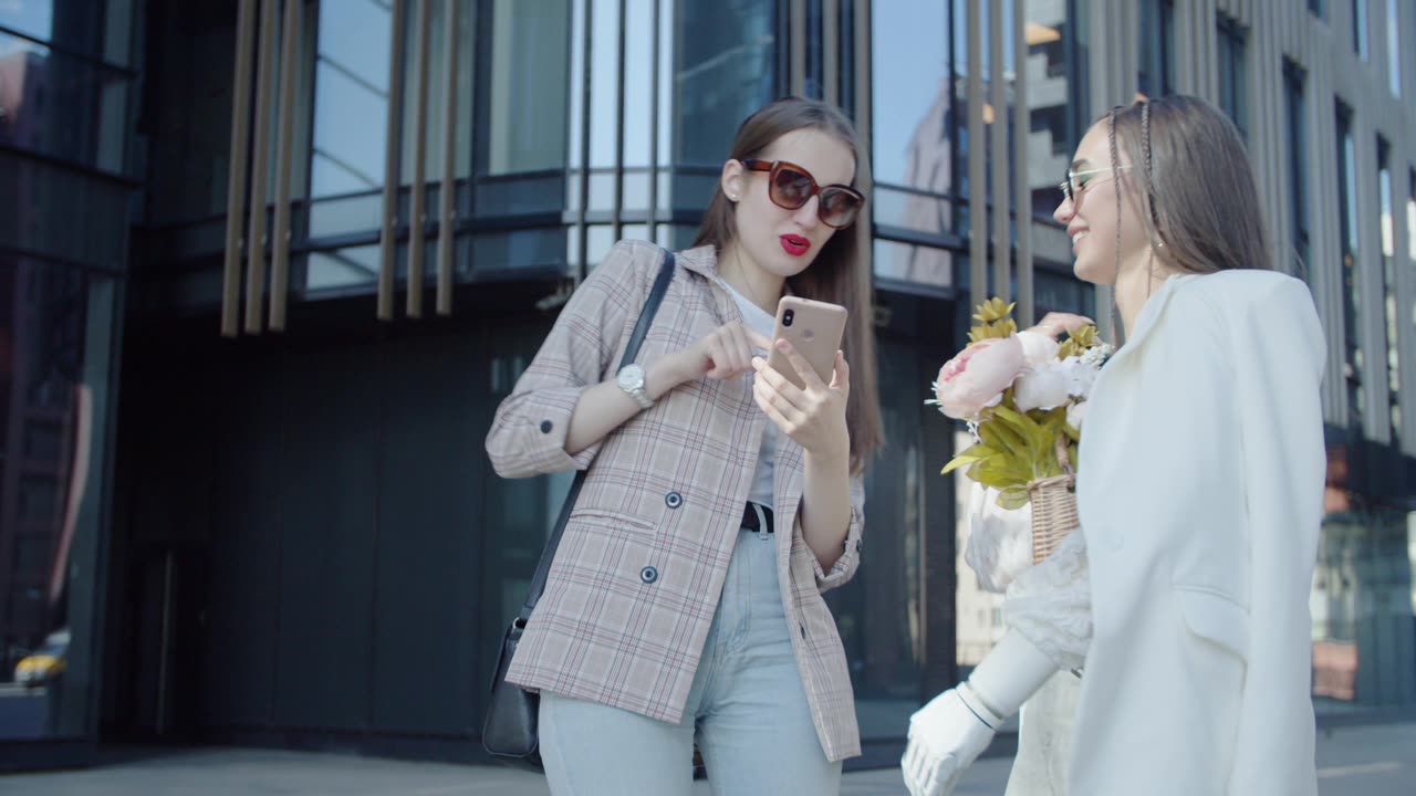 women having a conversation while looking at the screen