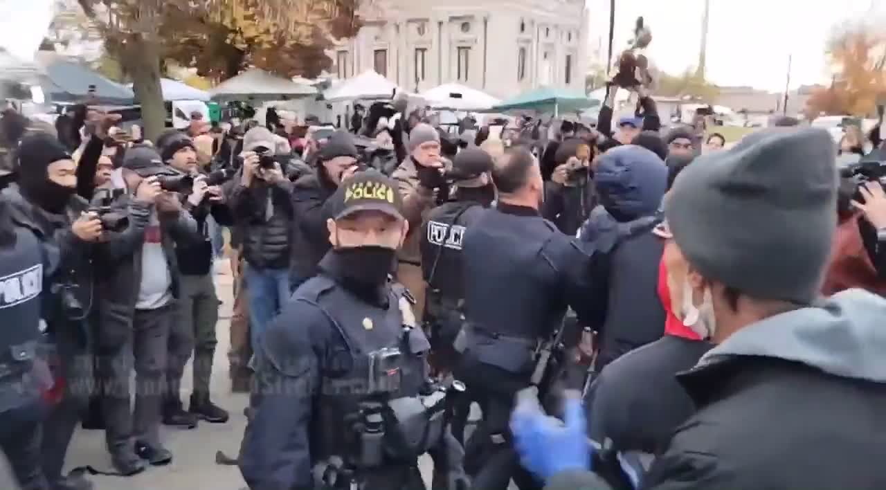 Police arrest two BLM supporters outside the courthouse of the Rittenhouse trial