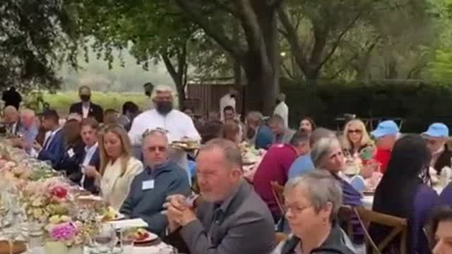 Democrats enjoying a meal, side by side, with Nancy Pelosi speaking