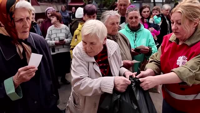 Displaced Ukrainians crowd for aid in Dnipro