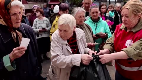 Displaced Ukrainians crowd for aid in Dnipro