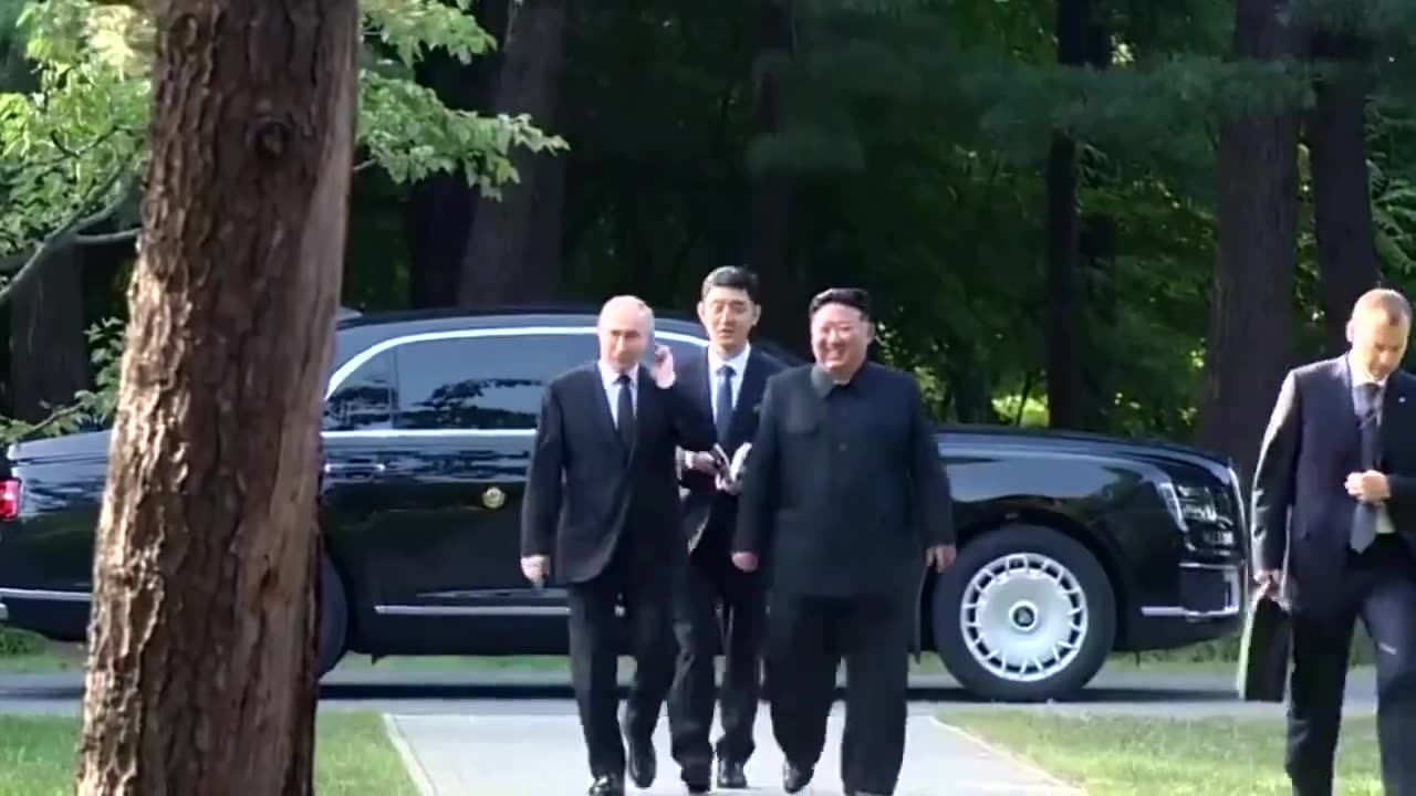 Putin driving North Korea's Kim Jong Un in a brand new Aurus Russian luxury car.