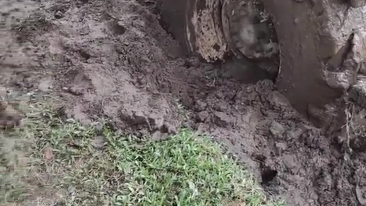 Indian tractor tire blew up in the field of mud