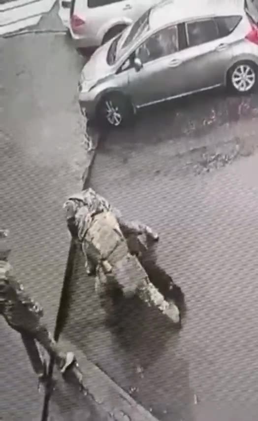 Ukrainian military registration and enlistment office hand a summons to a passerby