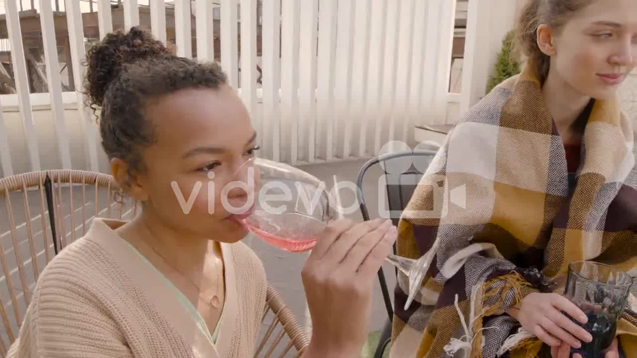 A Nice Multicultural Group Of Three Young Women Talking And Drinking Wine