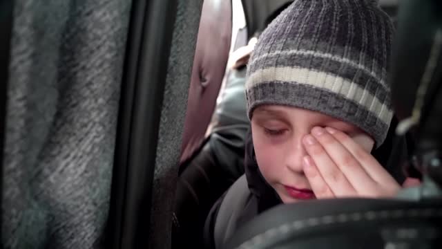 'We left our Dad in Kyiv' -little boy chokes back tears