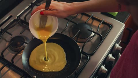 Woman serving eggs in a pan for breakfast