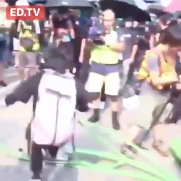 Crowd of masked Chinese people destroying a 5G Tower- April 2020