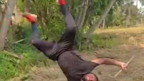 Man Performs Handstand Tricks While Balancing on Stick