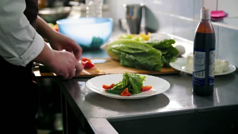 Chef preparing salad in the restaurant kitchen