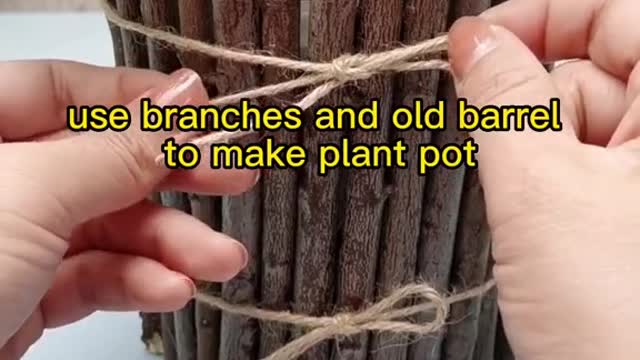 use branches and old barrel to make plant pot