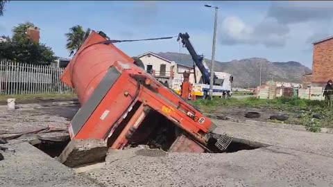 Waste truck swallowed by road in Lavender Hill