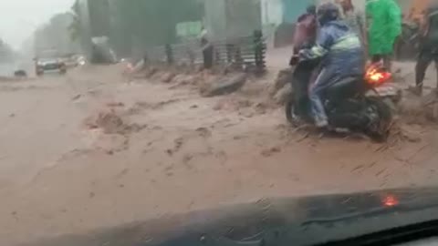 motorcyclist trying to break through the flood