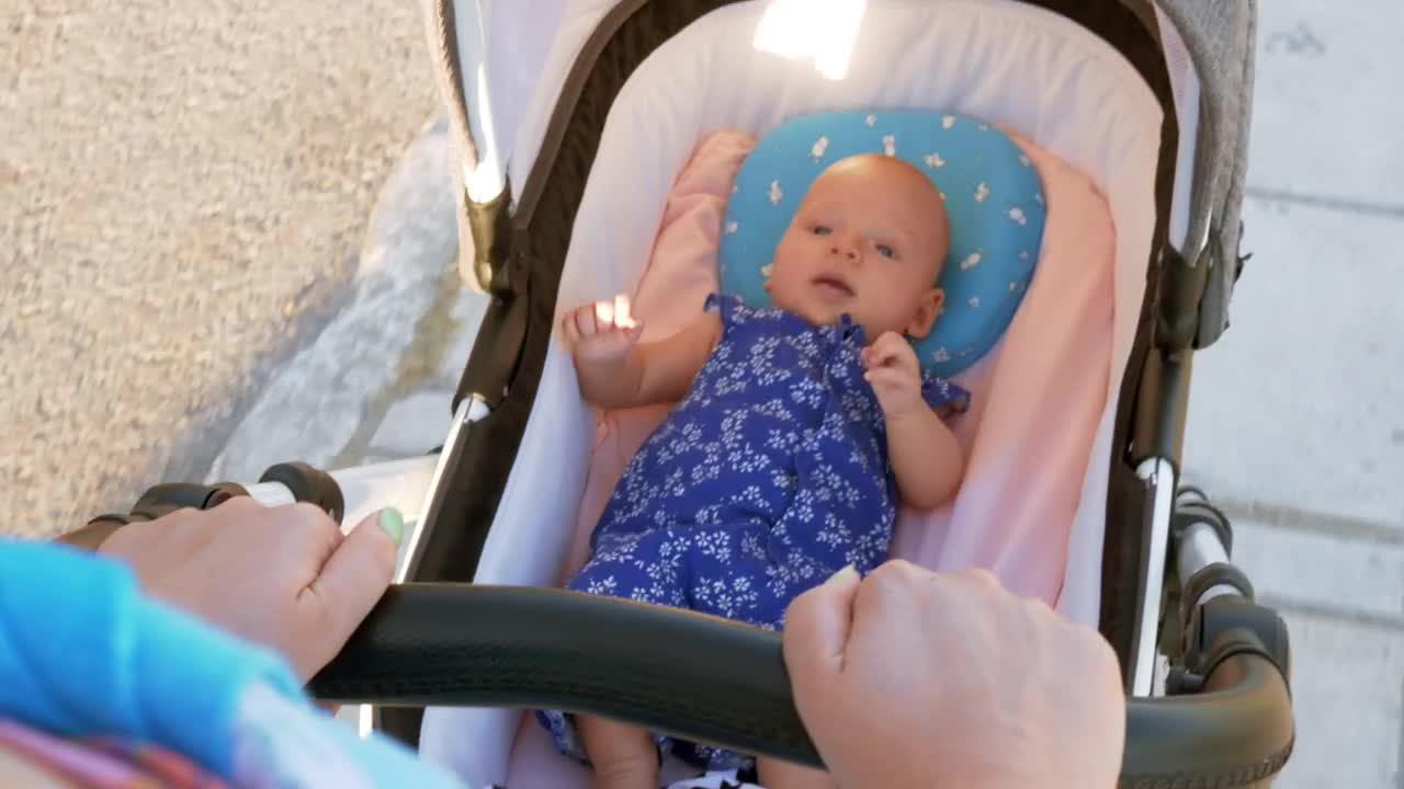 Pushing a young baby in a pram