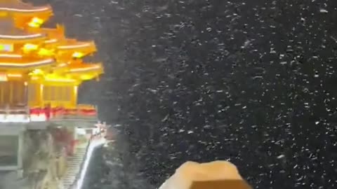 An entry view of a Chinese temple in the mountains during a storm