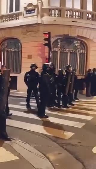 Some police officers in France remove their helmets and stop fighting with protesters.