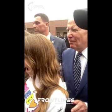 President Joe Biden grabs a young girl by the shoulder