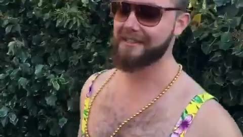 Man in dress jumps off house into bush