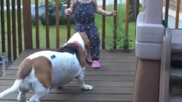 Little girl that playing (dancing) with a dog