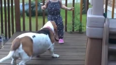 Little girl that playing (dancing) with a dog