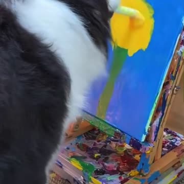 A dog paints a painting perfectly.