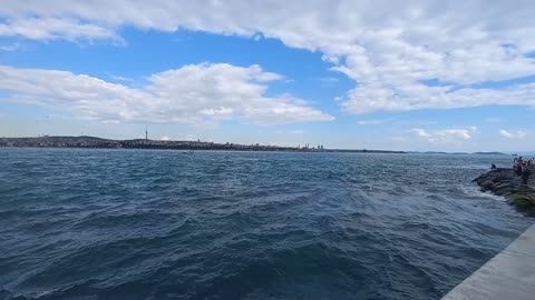 The beauty of the sea, calm waves and white clouds