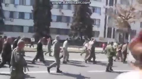 In Kharkov Russian troops are taking captured Ukranian Army through a square full of locals