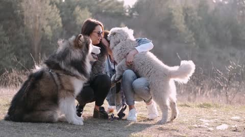 Women Holding Their Dogs