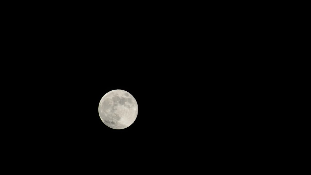 Time-lapse of the full moon on a dark night