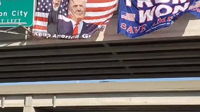 Huge Trump Flags displayed on a Hwy Bridge