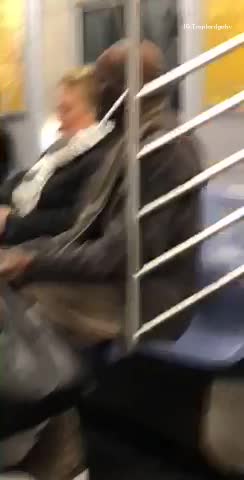 Man on subway has straws sticking into ears