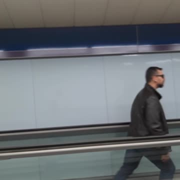 Guy dancing on flat escalator dance backwards