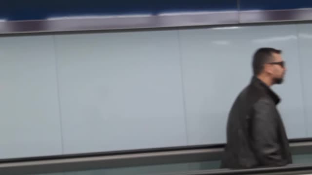 Guy dancing on flat escalator dance backwards